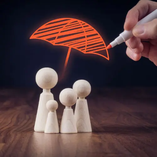 Wooden family figures beneath a hand-drawn umbrella representing insurance protection, financial security, risk management, and comprehensive family coverage.
