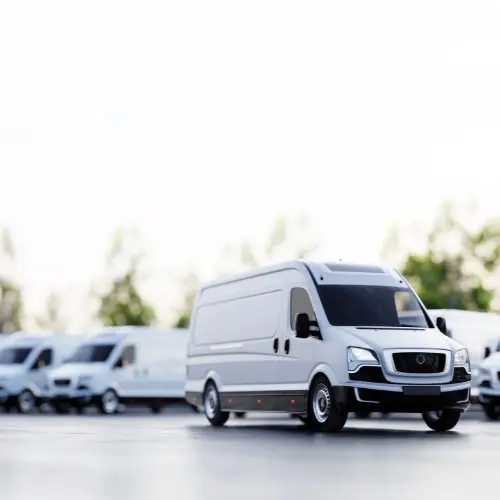 Fleet of commercial cargo vans representing commercial auto insurance, business vehicle coverage, fleet management, transportation risk, and commercial vehicle protection.