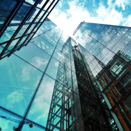 Modern glass office buildings representing commercial property insurance, commercial real estate, property risk management, and building coverage.